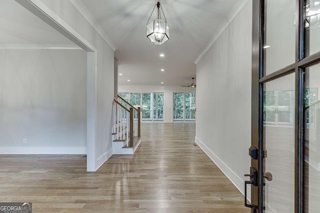 7620 Breeze Bay Rd, Cumming, GA 30041 - foyer featuring crown molding, stairs, wood finished floors, a ceiling fan, and baseboards
