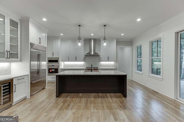 7620 Breeze Bay Rd, Cumming, GA 30041 - kitchen featuring wall chimney exhaust hood, stainless steel appliances, beverage cooler, tasteful backsplash, and light countertops