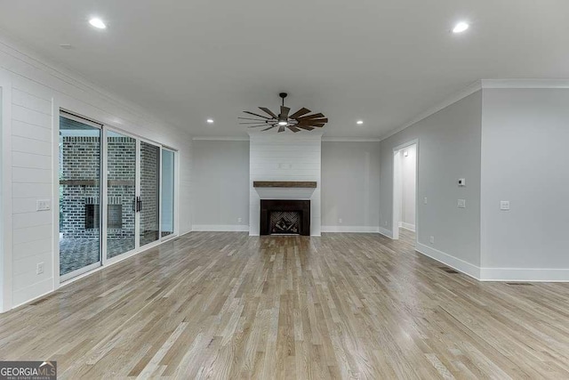 7620 Breeze Bay Rd, Cumming, GA 30041 - unfurnished living room with crown molding, ceiling fan, light wood-style flooring, a fireplace, and baseboards