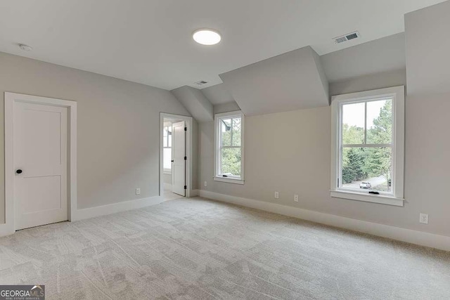7620 Breeze Bay Rd, Cumming, GA 30041 - unfurnished bedroom with baseboards, vaulted ceiling, light colored carpet, and ensuite bath