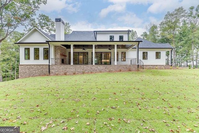 7620 Breeze Bay Rd, Cumming, GA 30041 - rear view of property featuring ceiling fan, a yard, a chimney, and brick siding