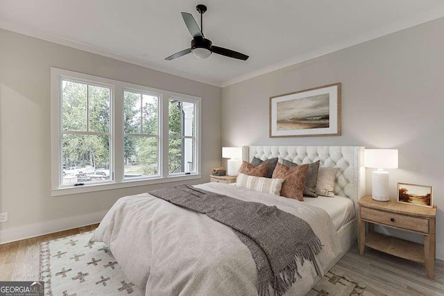 7620 Breeze Bay Rd, Cumming, GA 30041 - bedroom with ornamental molding, wood finished floors, baseboards, and a ceiling fan