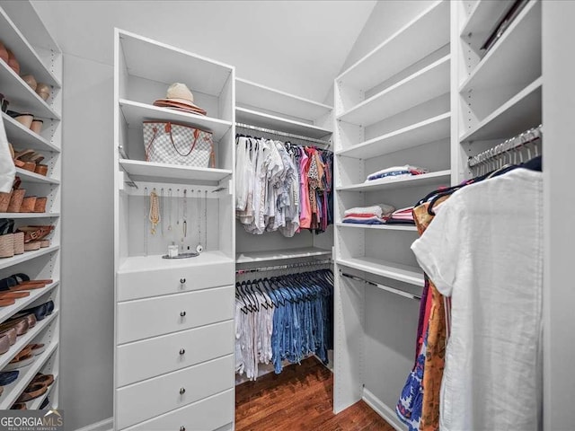 walk in closet featuring dark wood-style flooring and vaulted ceiling
