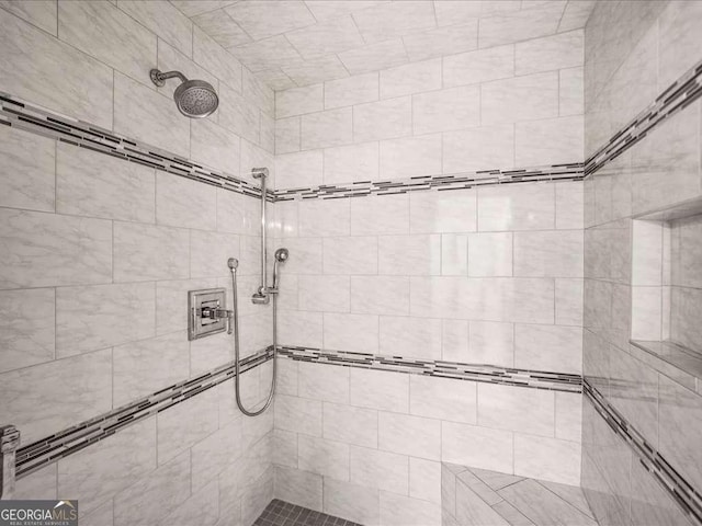 bathroom with tiled shower