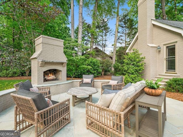 view of patio / terrace with an outdoor living space with a fireplace