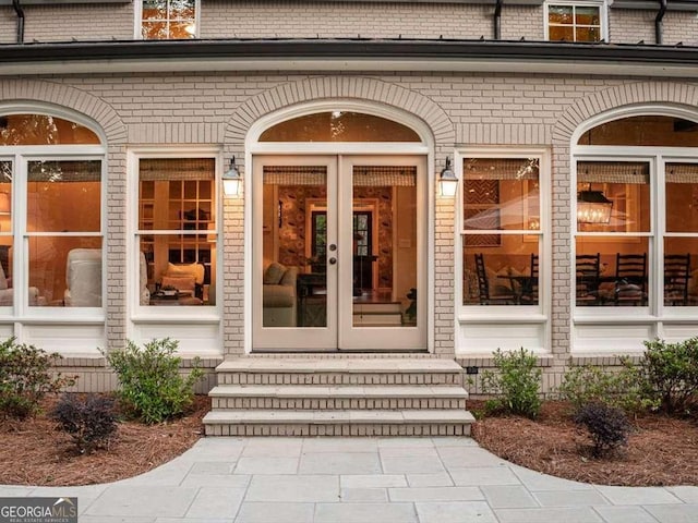 property entrance with french doors and brick siding