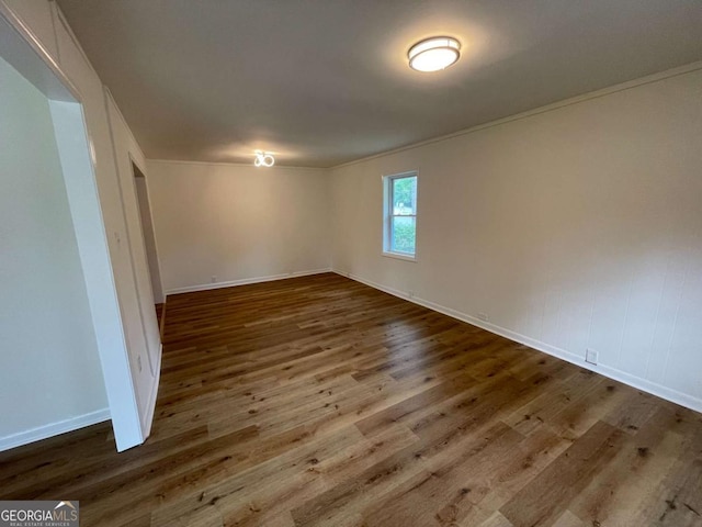 6927 Eunice Dr, Riverdale, GA 30274 - empty room featuring wood finished floors, baseboards, and crown molding