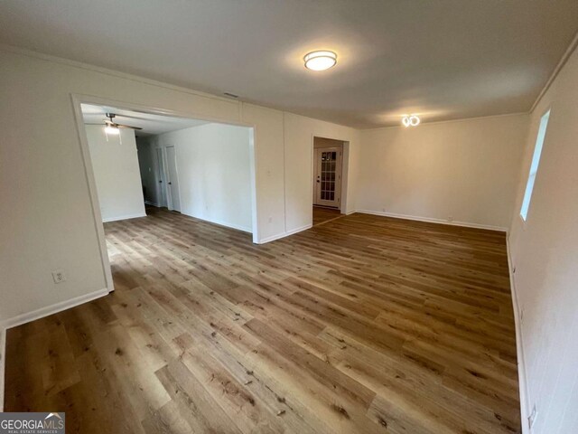 6927 Eunice Dr, Riverdale, GA 30274 - basement featuring wood finished floors, baseboards, a ceiling fan, and crown molding