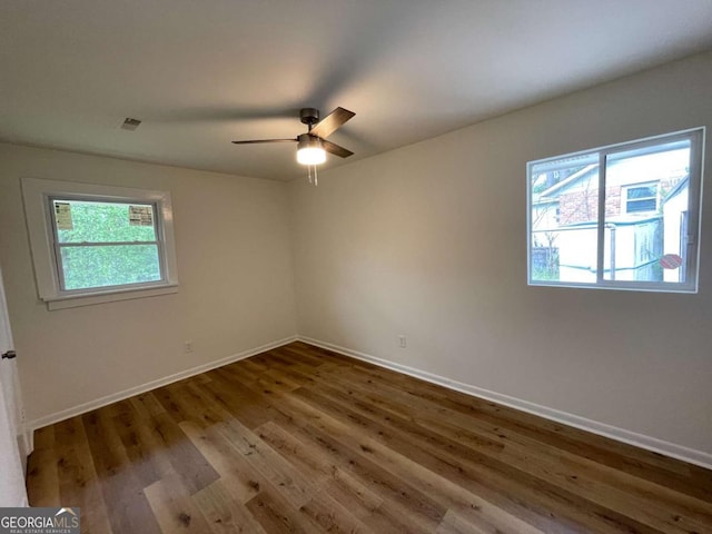 6927 Eunice Dr, Riverdale, GA 30274 - spare room featuring plenty of natural light, wood finished floors, and baseboards