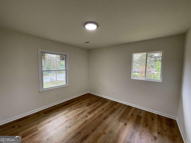 6927 Eunice Dr, Riverdale, GA 30274 - empty room with plenty of natural light, baseboards, and wood finished floors