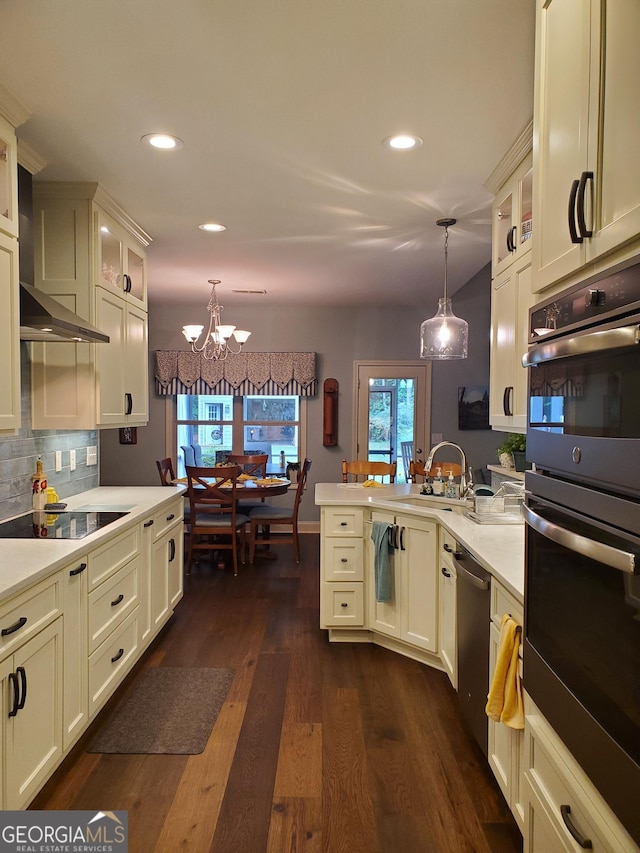 106 Hamway Ln, Winder, GA 30680 - kitchen featuring a sink, appliances with stainless steel finishes, pendant lighting, recessed lighting, and a chandelier