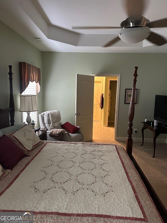 carpeted bedroom with ceiling fan and baseboards