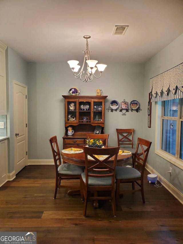 106 Hamway Ln, Winder, GA 30680 - dining space featuring a chandelier, dark wood-type flooring, and baseboards