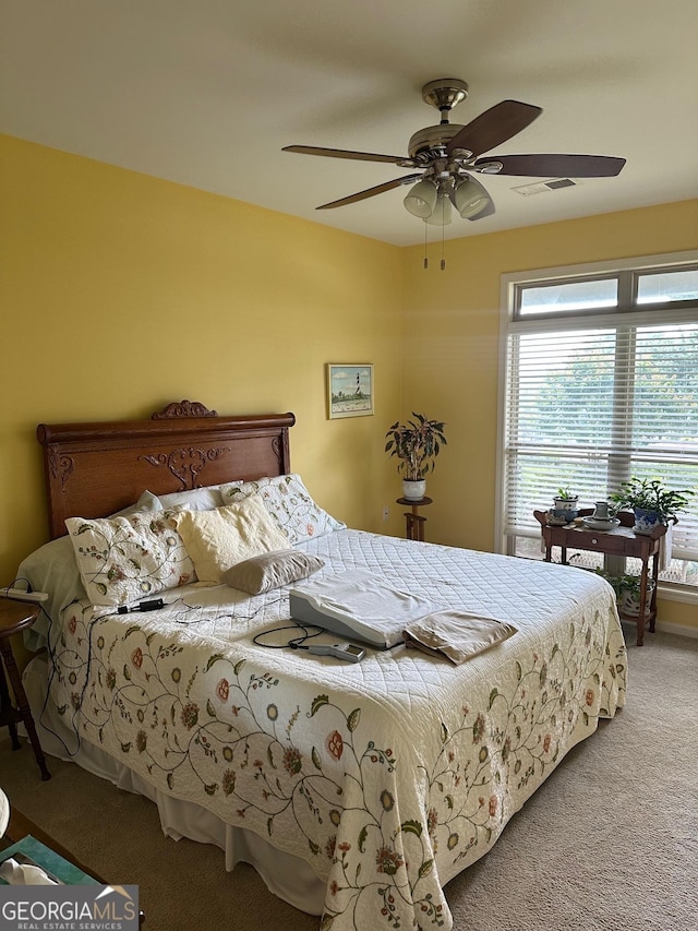 bedroom with carpet, multiple windows, and ceiling fan