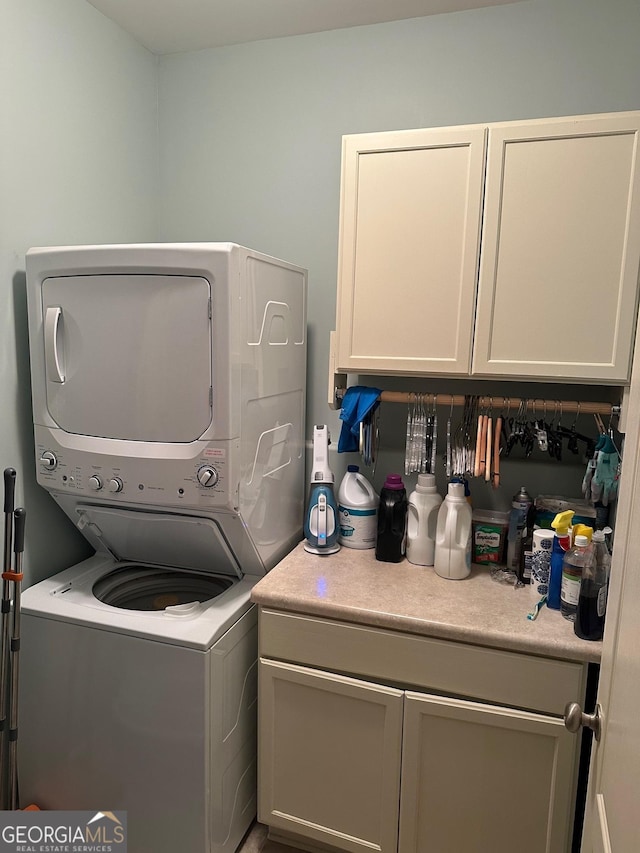 106 Hamway Ln, Winder, GA 30680 - washroom featuring stacked washer and clothes dryer and cabinet space