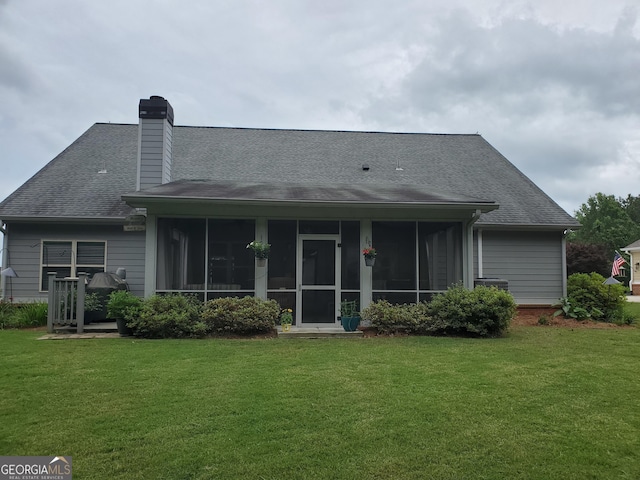 106 Hamway Ln, Winder, GA 30680 - rear view of house featuring a sunroom, a lawn, a chimney, and a shingled roof