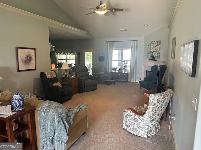 carpeted living area featuring vaulted ceiling, ceiling fan, and a fireplace