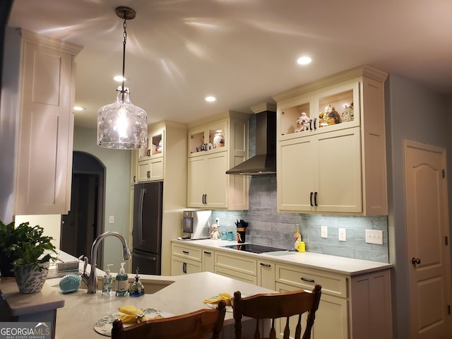 106 Hamway Ln, Winder, GA 30680 - kitchen featuring wall chimney exhaust hood, freestanding refrigerator, black electric cooktop, light countertops, and backsplash