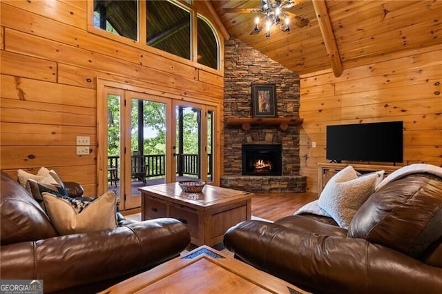 512 Picklesimer Mtn Rd, Morganton, GA 30560 - living area featuring wood finished floors, wood ceiling, wooden walls, a ceiling fan, and a stone fireplace