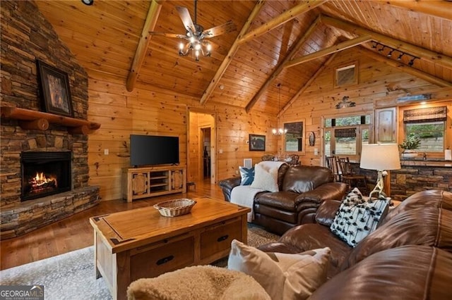 512 Picklesimer Mtn Rd, Morganton, GA 30560 - living area with hardwood / wood-style flooring, ceiling fan, wood walls, wood ceiling, and a stone fireplace