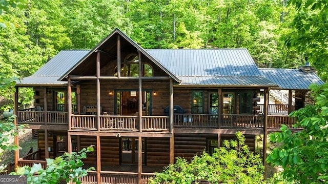 512 Picklesimer Mtn Rd, Morganton, GA 30560 - back of property with metal roof, a wooden deck, and a view of trees