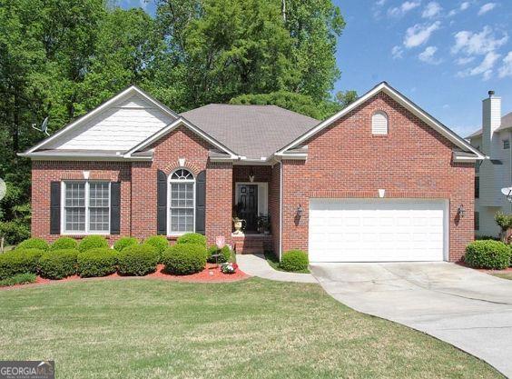 361 Brackin Trce, Grayson, GA 30017 - view of front of house with brick siding, a front lawn, driveway, and a garage