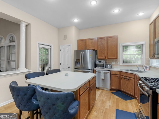 361 Brackin Trce, Grayson, GA 30017 - kitchen with stainless steel appliances, ornate columns, light wood-style flooring, and recessed lighting