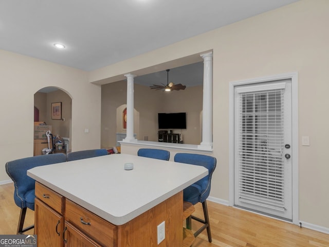 361 Brackin Trce, Grayson, GA 30017 - kitchen with a breakfast bar area, a ceiling fan, light wood-style flooring, light countertops, and recessed lighting