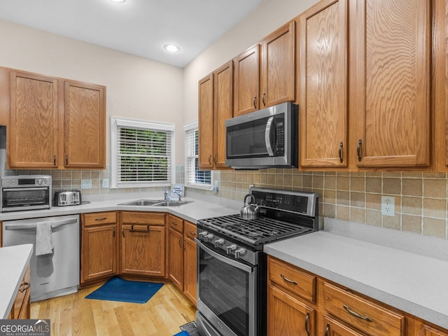 361 Brackin Trce, Grayson, GA 30017 - kitchen with stainless steel appliances, a sink, light countertops, light wood finished floors, and recessed lighting