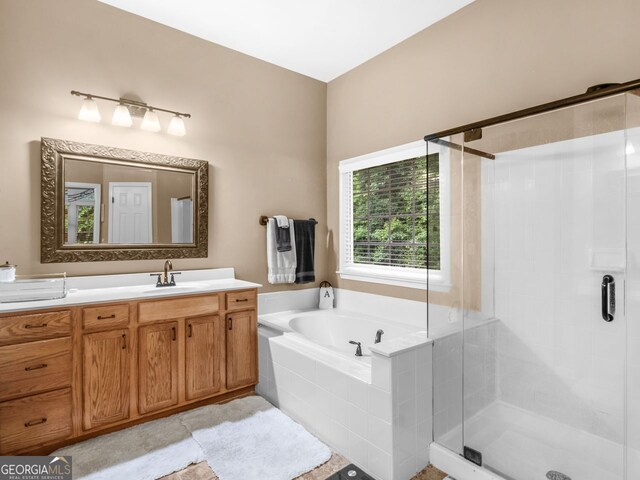 361 Brackin Trce, Grayson, GA 30017 - full bathroom featuring a shower stall, vanity, and a garden tub