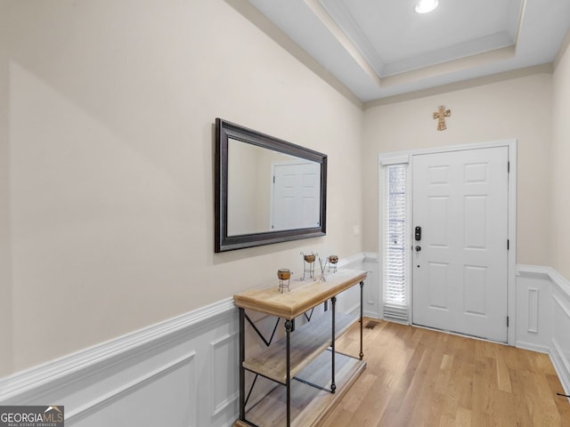 361 Brackin Trce, Grayson, GA 30017 - foyer with a wainscoted wall, a decorative wall, a raised ceiling, light wood-style floors, and ornamental molding