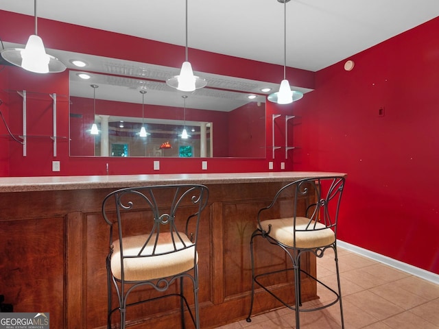 361 Brackin Trce, Grayson, GA 30017 - indoor wet bar featuring baseboards, tile patterned floors, and hanging light fixtures
