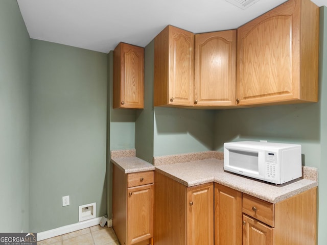 361 Brackin Trce, Grayson, GA 30017 - kitchen with white microwave, light countertops, light tile patterned floors, and baseboards