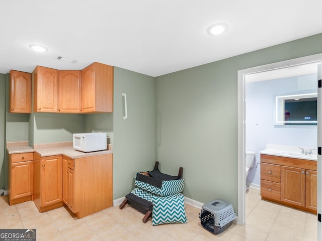 361 Brackin Trce, Grayson, GA 30017 - kitchen with white microwave, light countertops, and baseboards