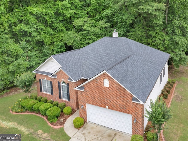 361 Brackin Trce, Grayson, GA 30017 - view of front facade with brick siding, an attached garage, concrete driveway, and roof with shingles