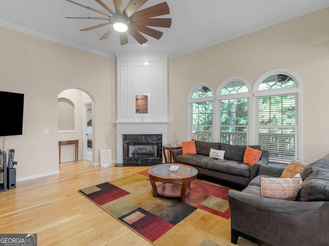 361 Brackin Trce, Grayson, GA 30017 - living area featuring a ceiling fan, wood finished floors, crown molding, arched walkways, and a premium fireplace