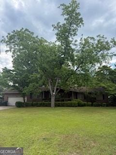 111 Roberson St, Dublin, GA 31021 - view of grassy yard featuring a garage