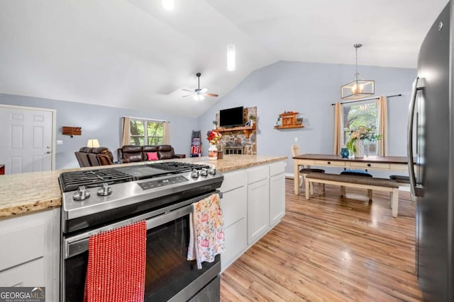 115 S Meadowcliff Cir, Carrollton, GA 30116 - kitchen featuring stainless steel appliances, open floor plan, ceiling fan, white cabinets, and lofted ceiling