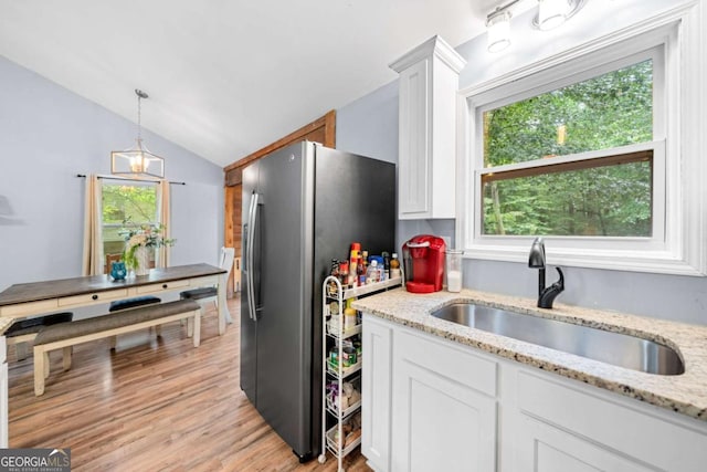 115 S Meadowcliff Cir, Carrollton, GA 30116 - kitchen with a sink, freestanding refrigerator, white cabinets, vaulted ceiling, and light wood-type flooring