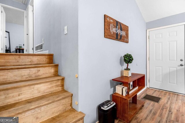 115 S Meadowcliff Cir, Carrollton, GA 30116 - stairs with wood finished floors and vaulted ceiling