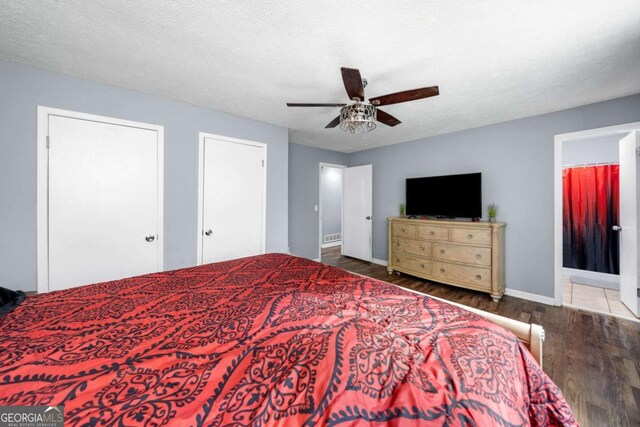 115 S Meadowcliff Cir, Carrollton, GA 30116 - bedroom with wood finished floors, baseboards, multiple closets, and a ceiling fan