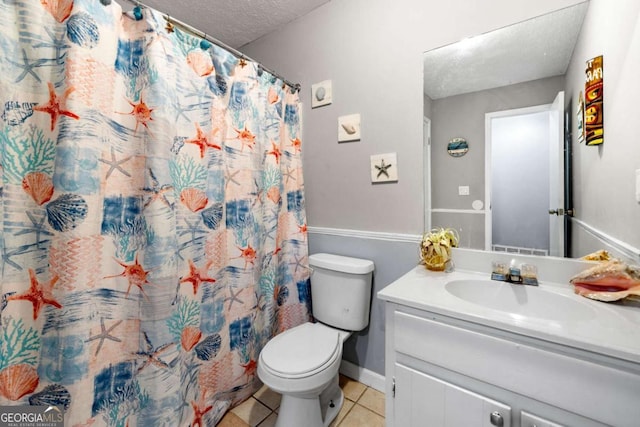 115 S Meadowcliff Cir, Carrollton, GA 30116 - full bathroom featuring tile patterned floors, a textured ceiling, vanity, toilet, and baseboards
