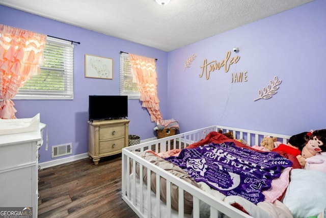 115 S Meadowcliff Cir, Carrollton, GA 30116 - bedroom featuring wood finished floors, a textured ceiling, and baseboards