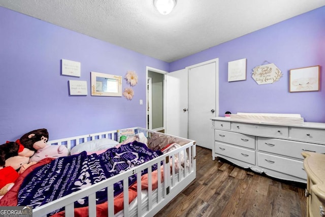 115 S Meadowcliff Cir, Carrollton, GA 30116 - bedroom featuring dark wood-type flooring and a textured ceiling