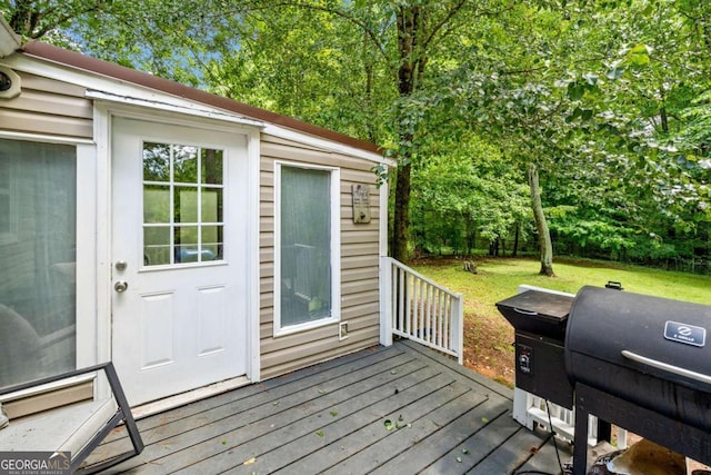 115 S Meadowcliff Cir, Carrollton, GA 30116 - wooden deck with area for grilling and a lawn