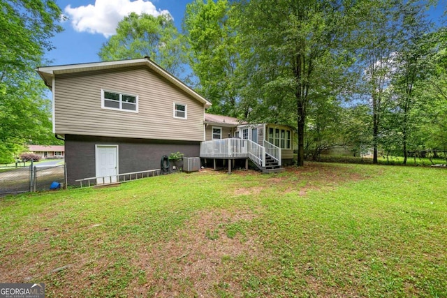 115 S Meadowcliff Cir, Carrollton, GA 30116 - rear view of house with a sunroom, a fenced backyard, and a deck