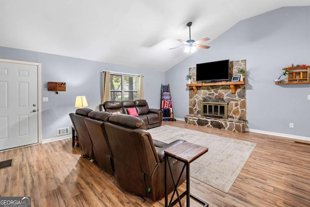 115 S Meadowcliff Cir, Carrollton, GA 30116 - living area featuring a ceiling fan, lofted ceiling, wood finished floors, baseboards, and a stone fireplace