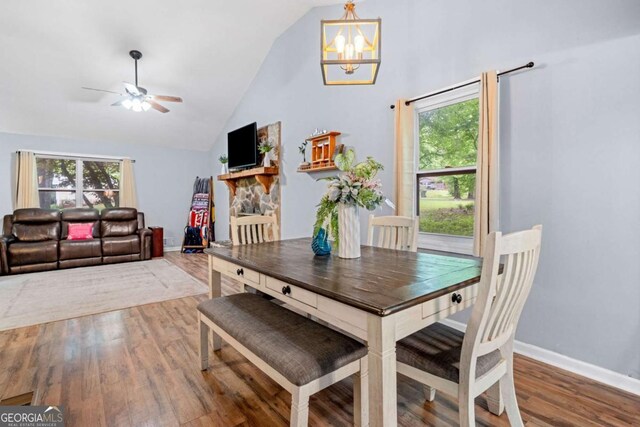 115 S Meadowcliff Cir, Carrollton, GA 30116 - dining area featuring wood finished floors, ceiling fan, a chandelier, baseboards, and high vaulted ceiling