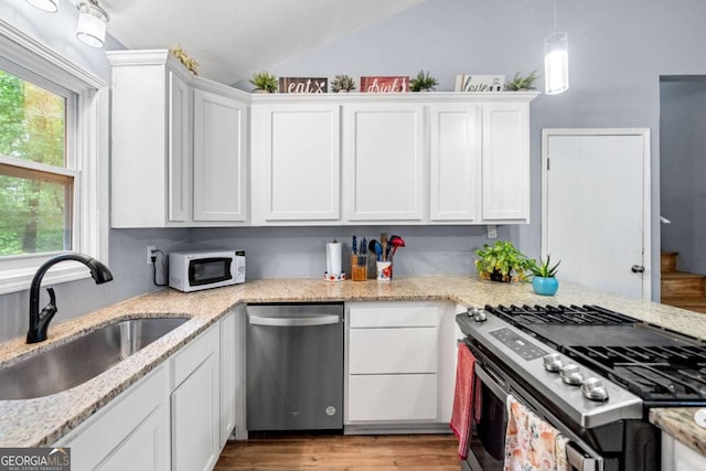 115 S Meadowcliff Cir, Carrollton, GA 30116 - kitchen featuring stainless steel appliances, a sink, vaulted ceiling, plenty of natural light, and white cabinets