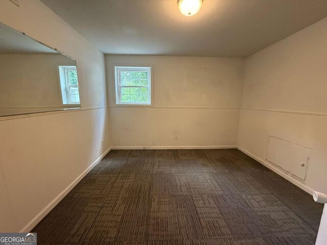 5460 Huron Dr, Morrow, GA 30260 - basement with dark carpet and baseboards
